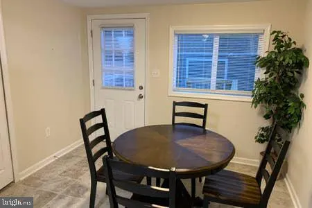 a backyard of a house with table and chairs