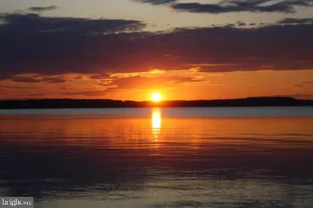 a kitchen with stainless steel appliances granite countertop a stove refrigerator sink and microwave