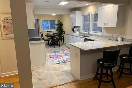 6145 5th Street King George, VA 22485 - Photo 25 of 29 a kitchen with stainless steel appliances kitchen island granite countertop a sink and a refrigerator