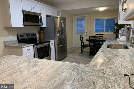 6145 5th Street King George, VA 22485 - Photo 3 of 29 a kitchen with stainless steel appliances granite countertop a stove refrigerator sink and microwave