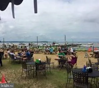 a living room with furniture a rug and kitchen view