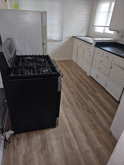 114 North J Street Madera, CA 93637 - Photo 18 of 20 a kitchen with granite countertop a stove and a refrigerator