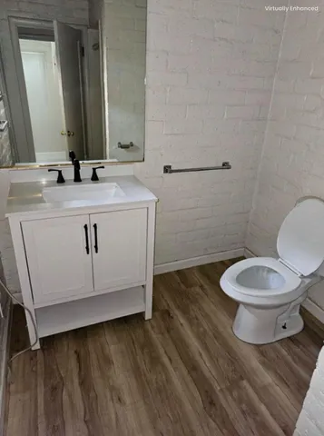 a bathroom with a sink mirror vanity and toilet