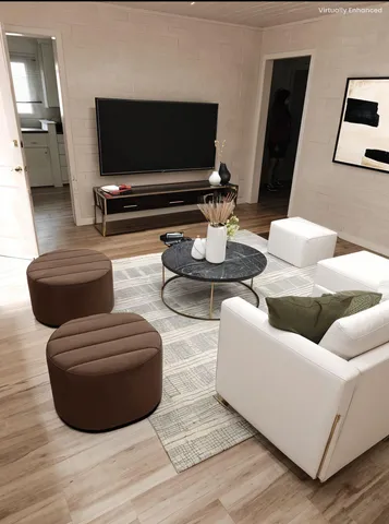 a living room with furniture and a flat screen tv