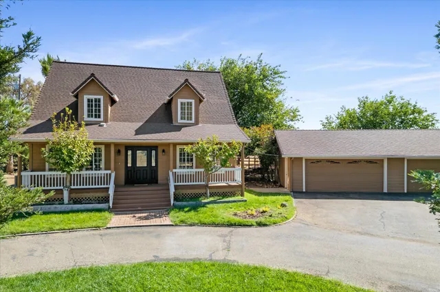 a front view of a house with a garden and plants