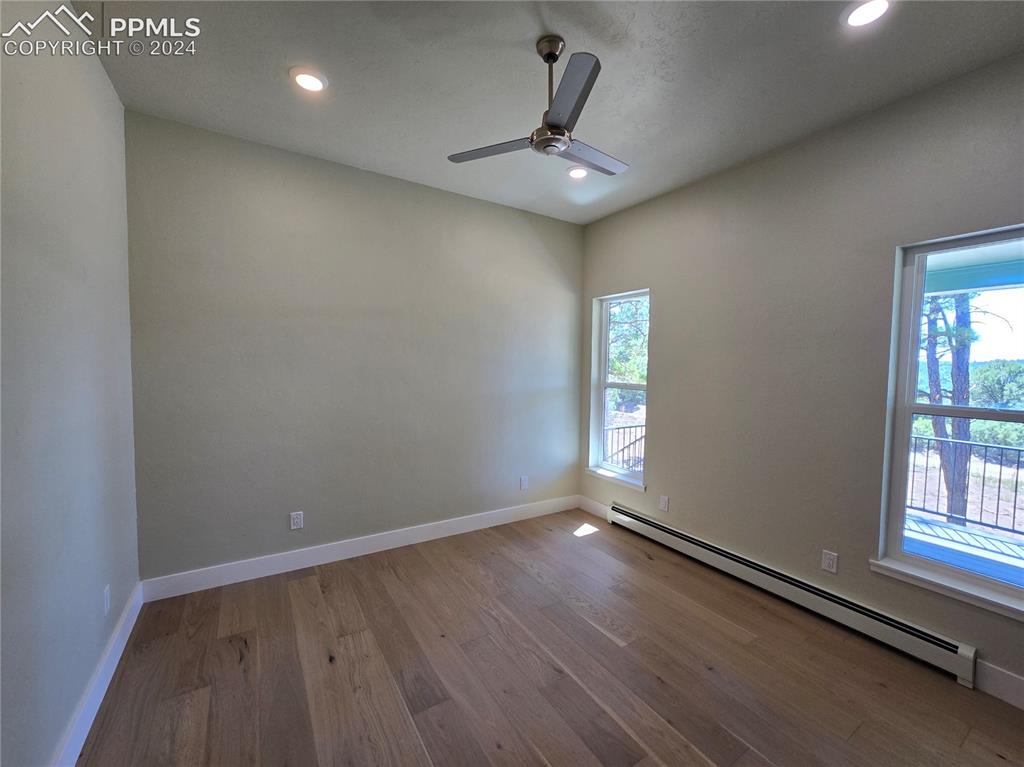 33036 Meadow Ridge Lane Trinidad, CO 81082 - Photo 30 of 50 Primary bedroom with a baseboard heating unit, ceiling fan, and light hardwood / wood-style floors