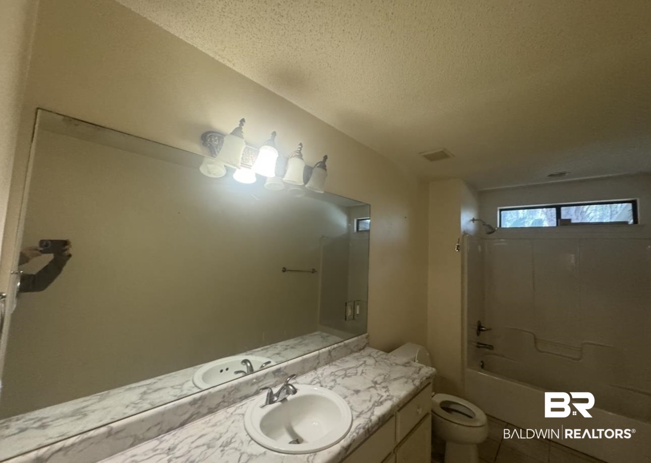 23341 County Road 49 Silverhill, AL 36576 - Photo 10 of 23 Bathroom featuring vanity, shower / washtub combination, a textured ceiling, and light tile patterned floors