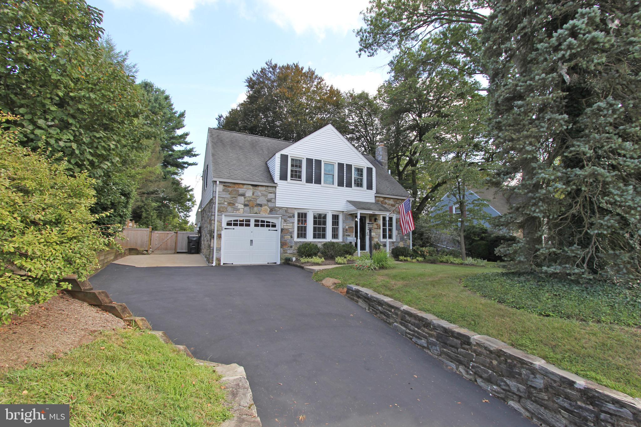 951 Conestoga Road Berwyn, PA 19312 - Photo 2 of 41 a view of a house with a big yard and large trees