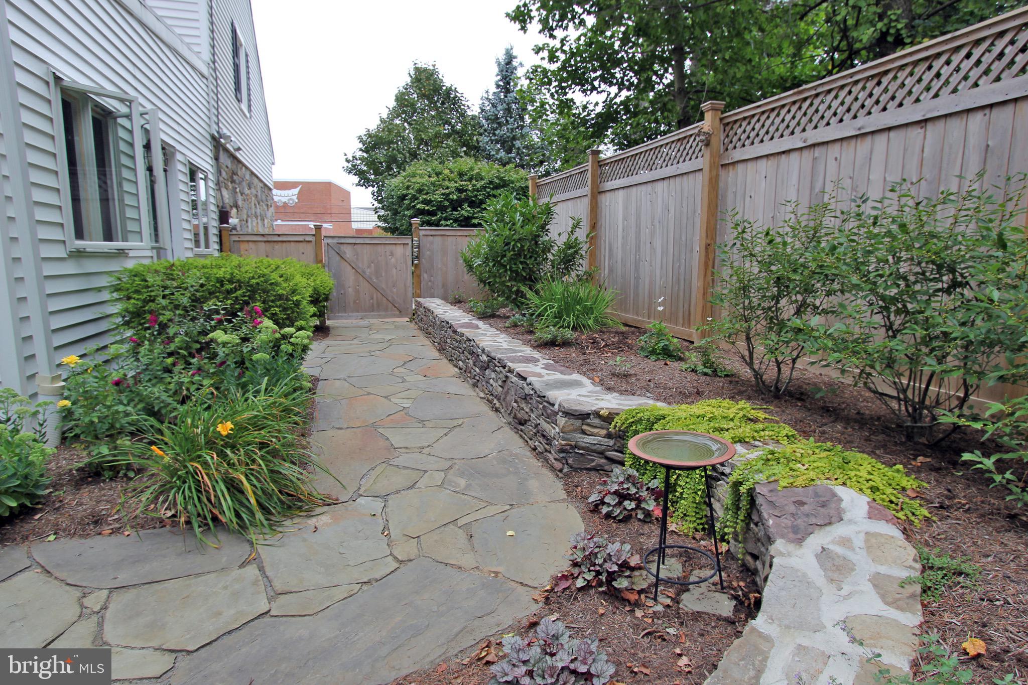 951 Conestoga Road Berwyn, PA 19312 - Photo 21 of 41 a view of a backyard with plants and furniture