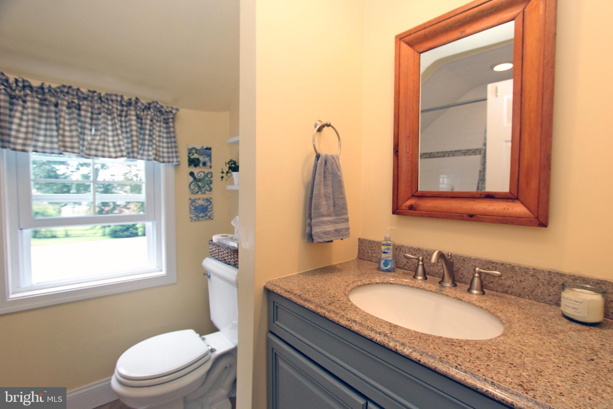 951 Conestoga Road Berwyn, PA 19312 - Photo 25 of 41 a bathroom with a granite countertop sink toilet and mirror
