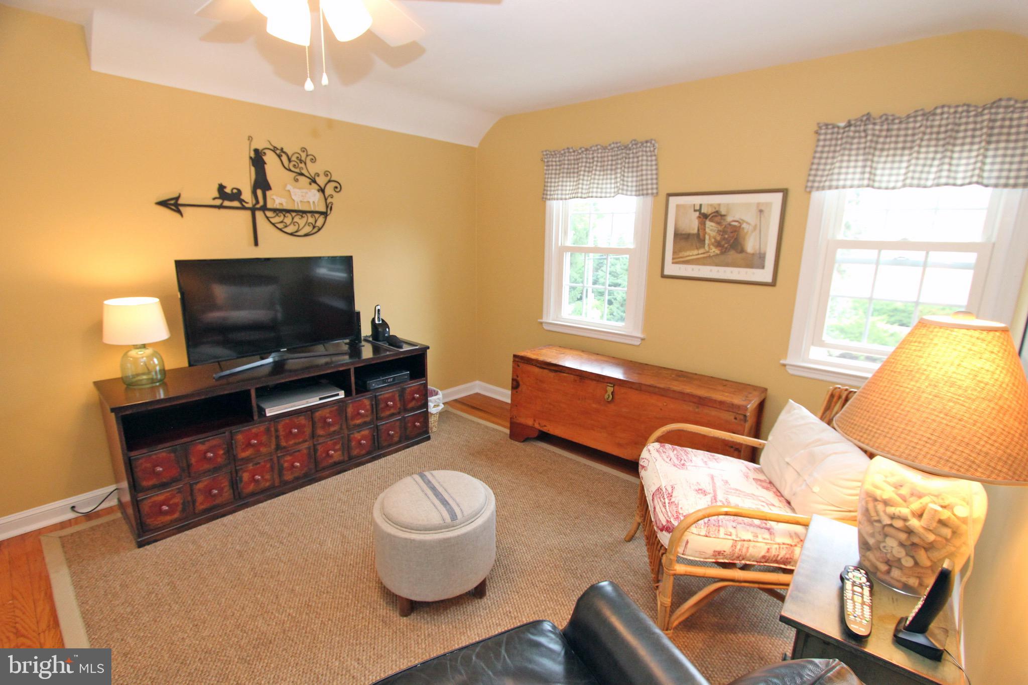 951 Conestoga Road Berwyn, PA 19312 - Photo 29 of 41 a living room with furniture a flat screen tv and a window