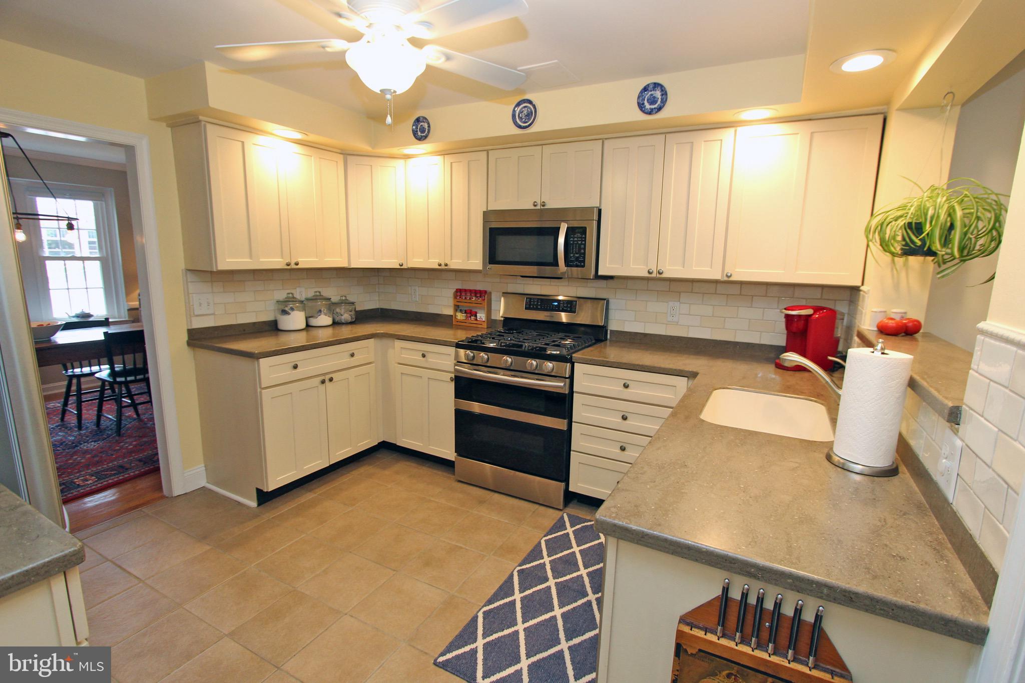 951 Conestoga Road Berwyn, PA 19312 - Photo 7 of 41 a kitchen with granite countertop a sink stainless steel appliances and cabinets
