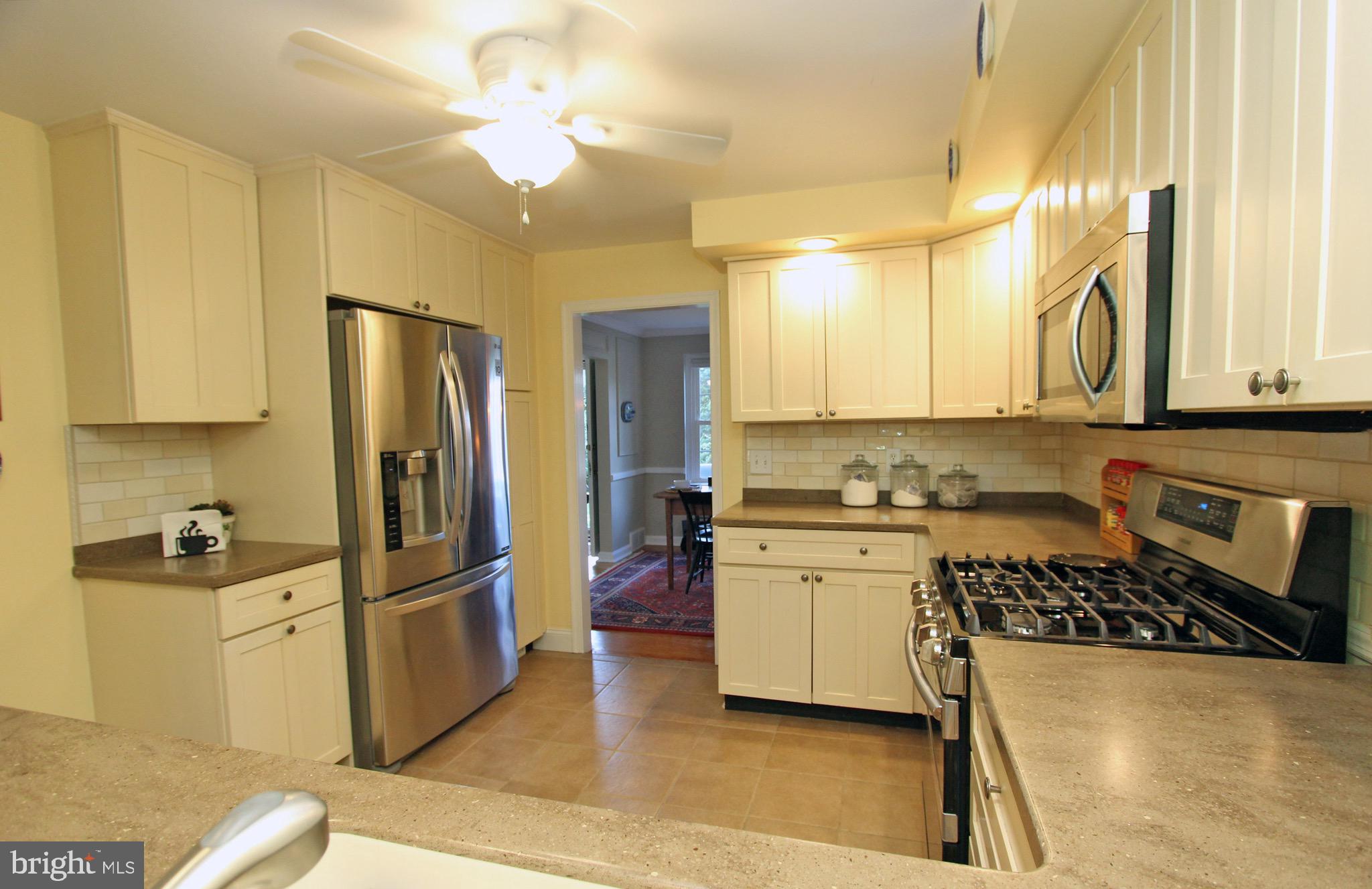 951 Conestoga Road Berwyn, PA 19312 - Photo 9 of 41 a kitchen with refrigerator a stove and a cabinets