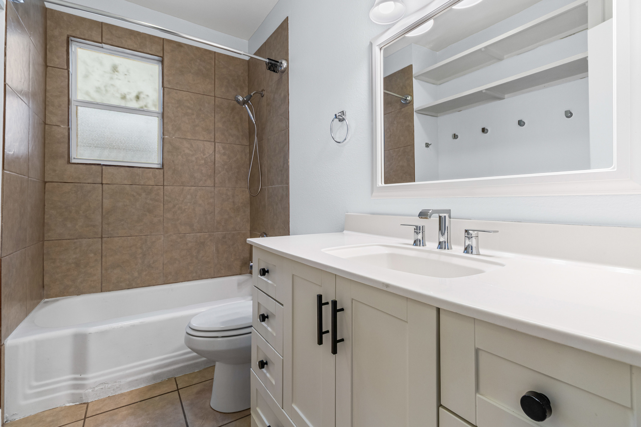 84 Waller Street Austin, TX 78702 - Photo 12 of 22 Full bathroom with vanity, washtub / shower combination, and light tile patterned floors