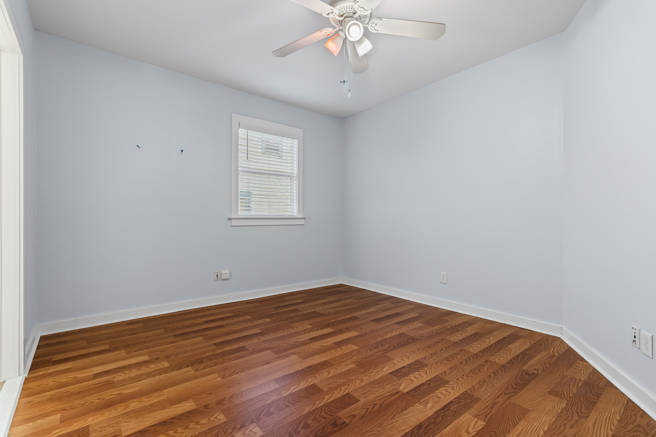 84 Waller Street Austin, TX 78702 - Photo 13 of 22 Unfurnished room featuring dark wood-style flooring and a ceiling fan