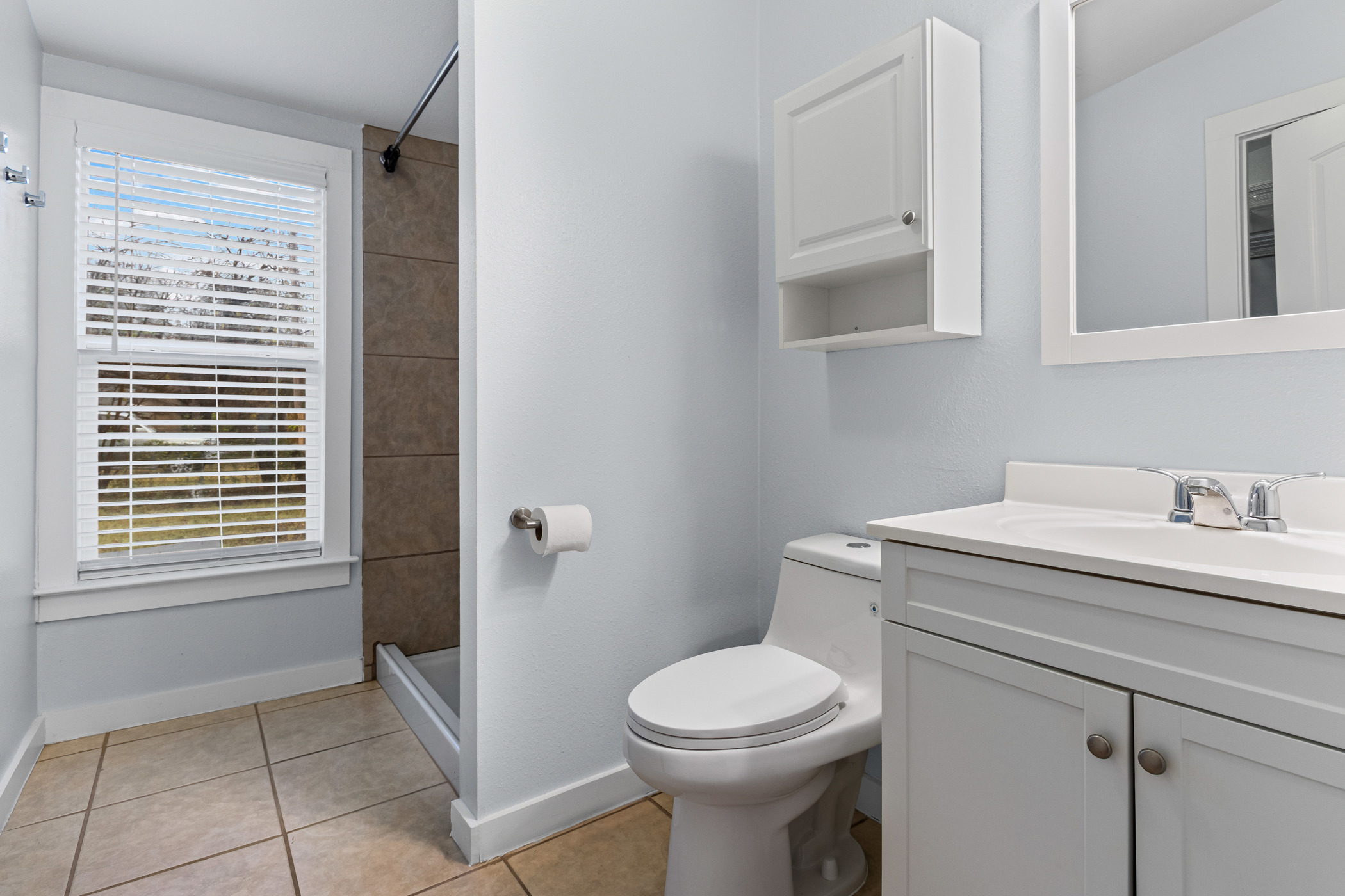 84 Waller Street Austin, TX 78702 - Photo 16 of 22 Bathroom with vanity, a stall shower, and light tile patterned flooring