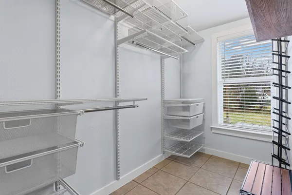 a room with walk in closet and window