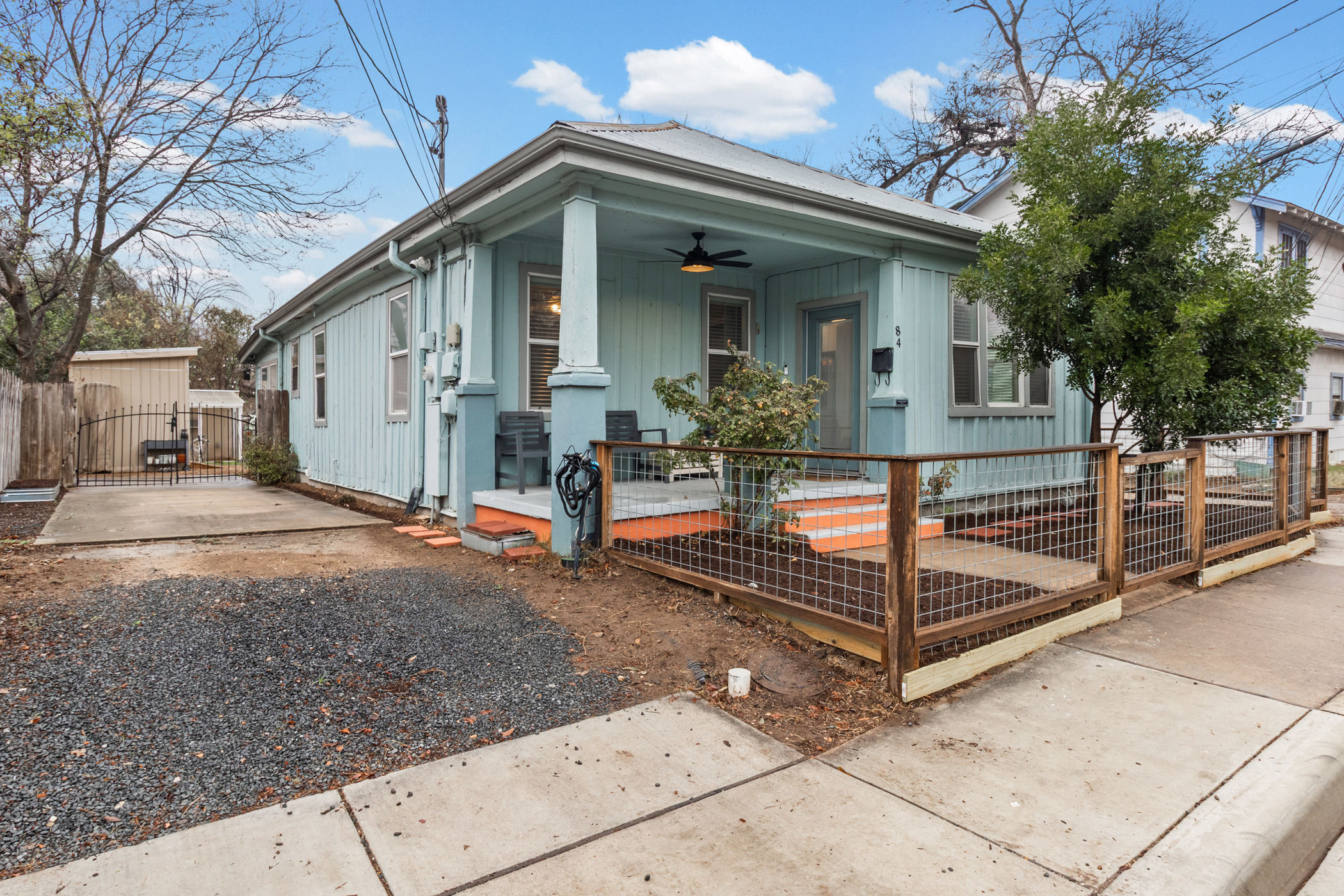 84 Waller Street Austin, TX 78702 - Photo 2 of 22 View of front of home featuring a gate, covered porch, a fenced front yard, and ceiling fan