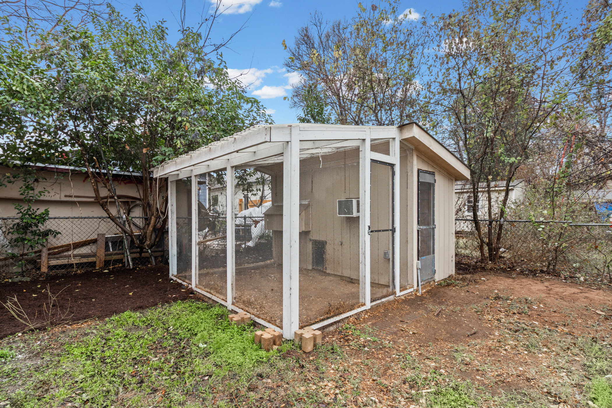 84 Waller Street Austin, TX 78702 - Photo 21 of 22 View of poultry coop with a fenced backyard and a sunroom