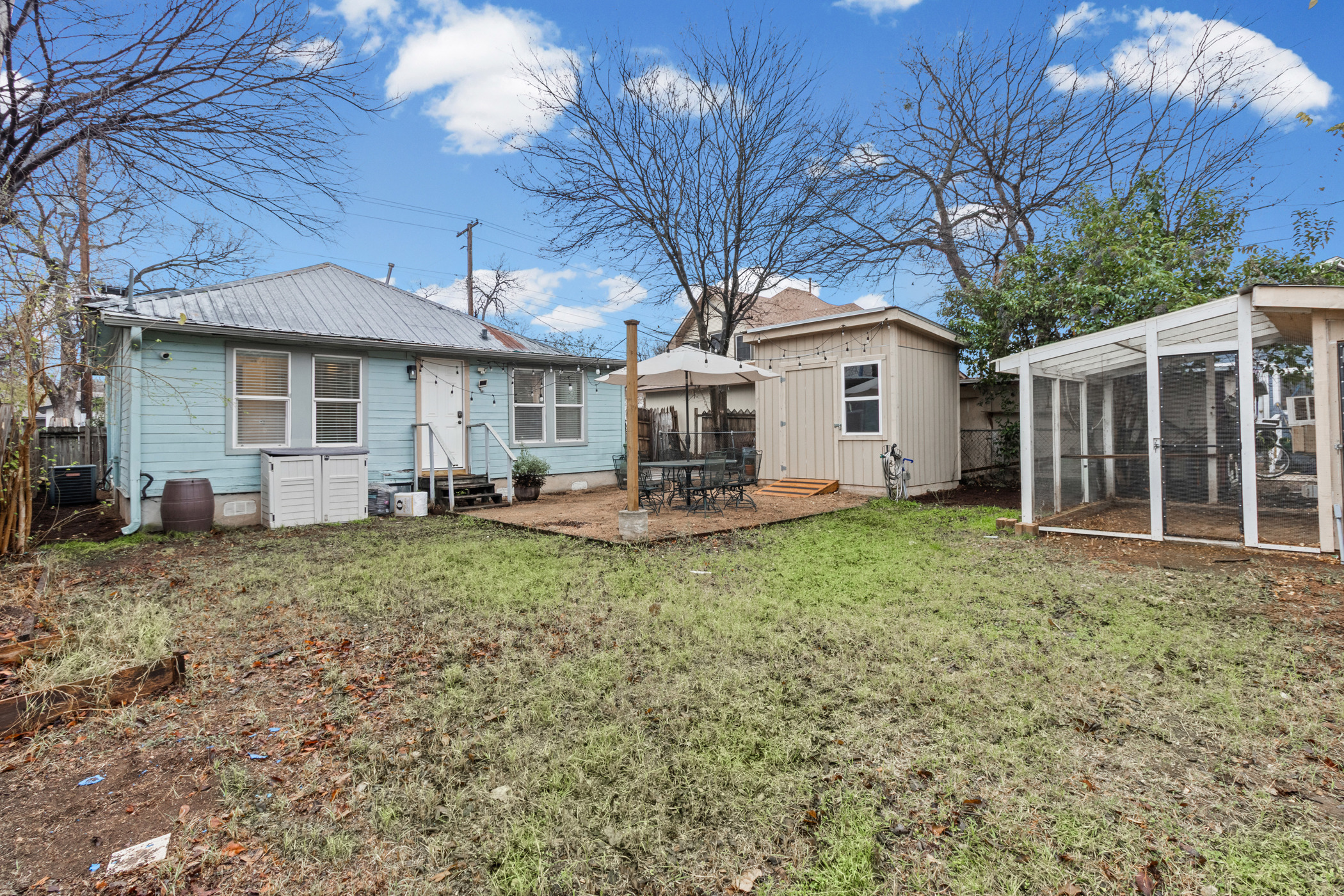 84 Waller Street Austin, TX 78702 - Photo 22 of 22 Rear view of house featuring a patio area, an outdoor structure, entry steps, and a metal roof