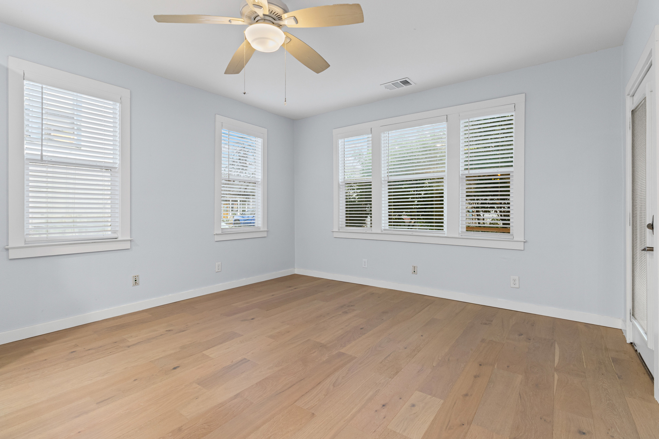 84 Waller Street Austin, TX 78702 - Photo 5 of 22 Spare room with light wood finished floors and ceiling fan