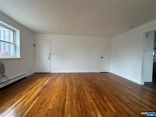 an empty room with wooden floor