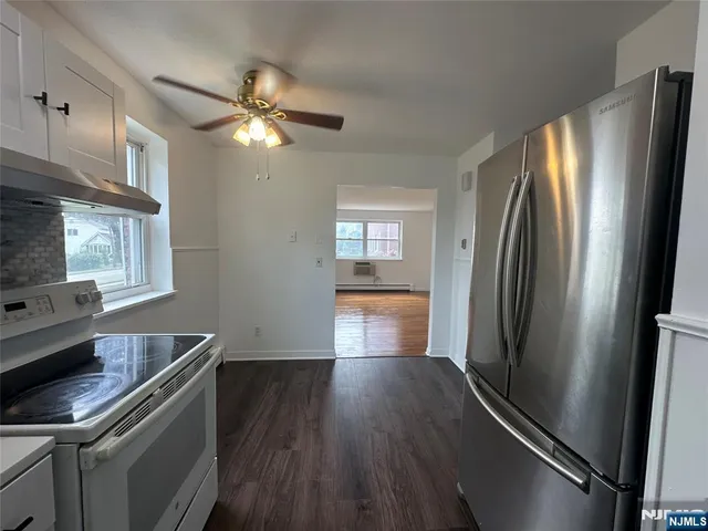a kitchen with stainless steel appliances a refrigerator and a stove