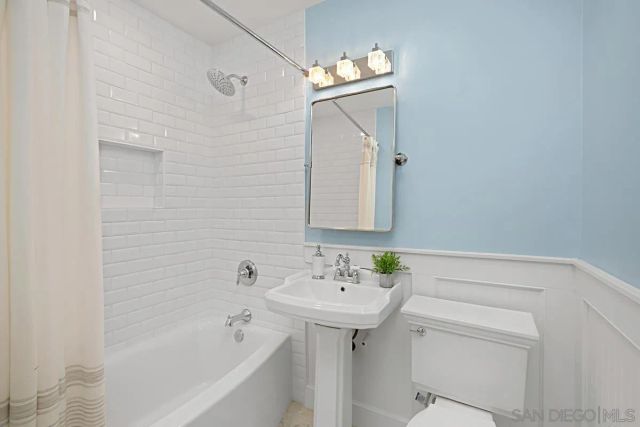a bathroom with a sink a mirror and shower