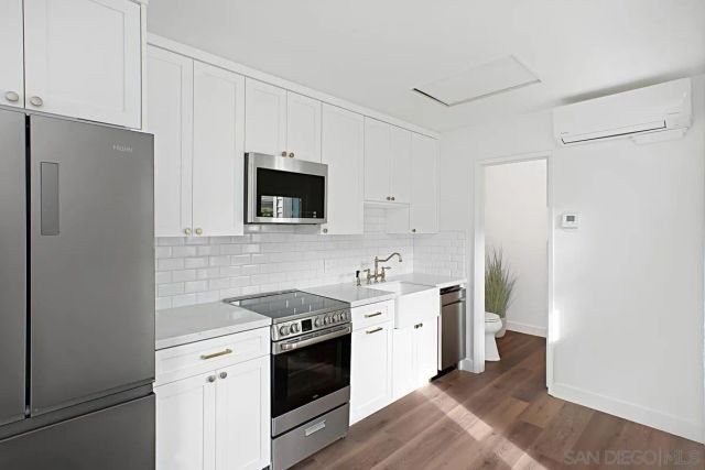 a kitchen with a sink stove and refrigerator