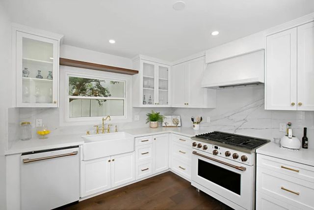 a kitchen with a sink stove and cabinets