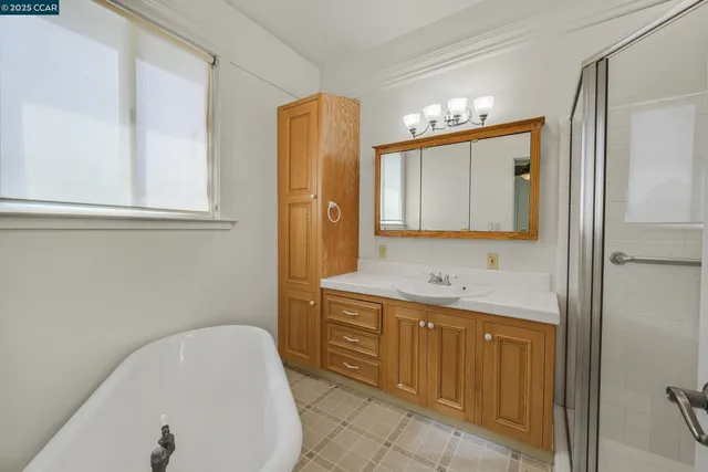 a bathroom with a tub sink and mirror