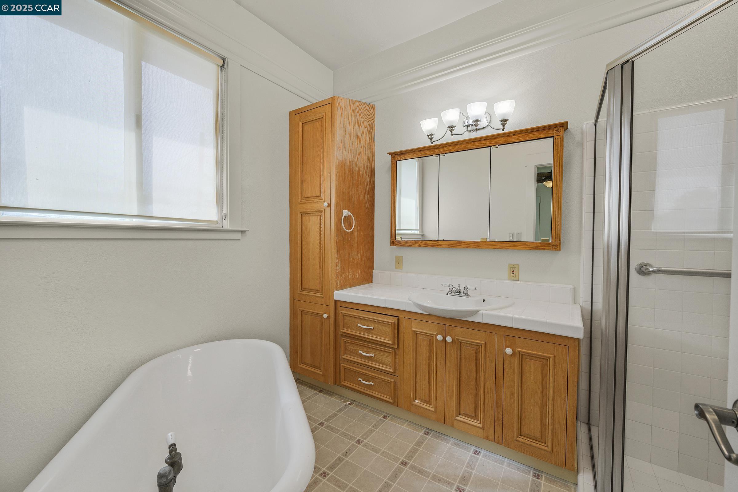 2581 Charles Avenue Pinole, CA 94564 - Photo 12 of 50 a bathroom with a tub sink and mirror
