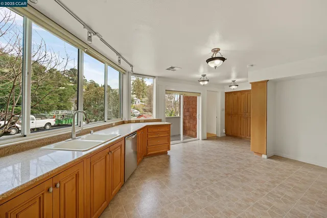 a large white kitchen with a large window
