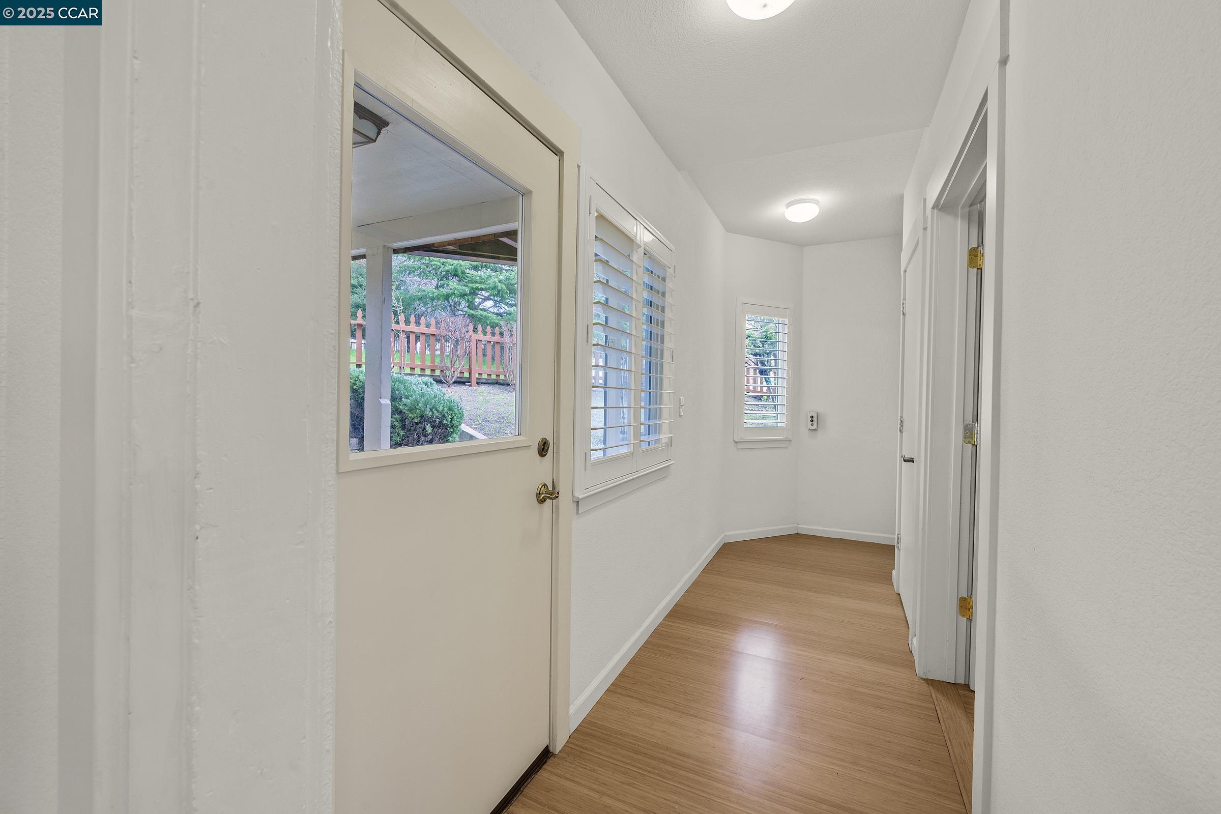 2581 Charles Avenue Pinole, CA 94564 - Photo 23 of 50 a view of a hallway with wooden floor and a window