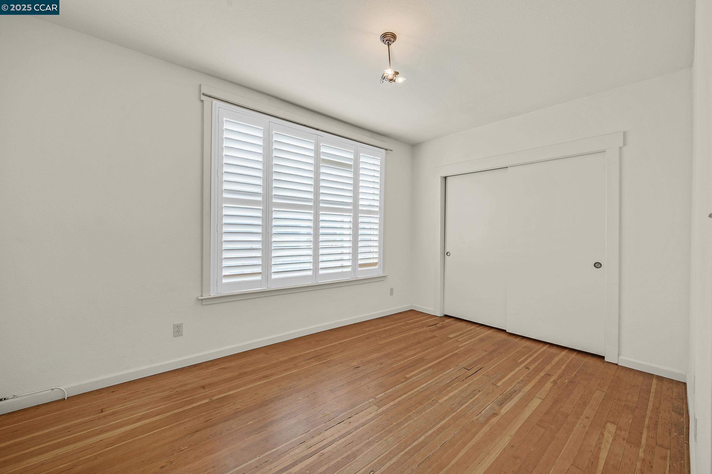 2581 Charles Avenue Pinole, CA 94564 - Photo 24 of 50 a view of an empty room with wooden floor and a window