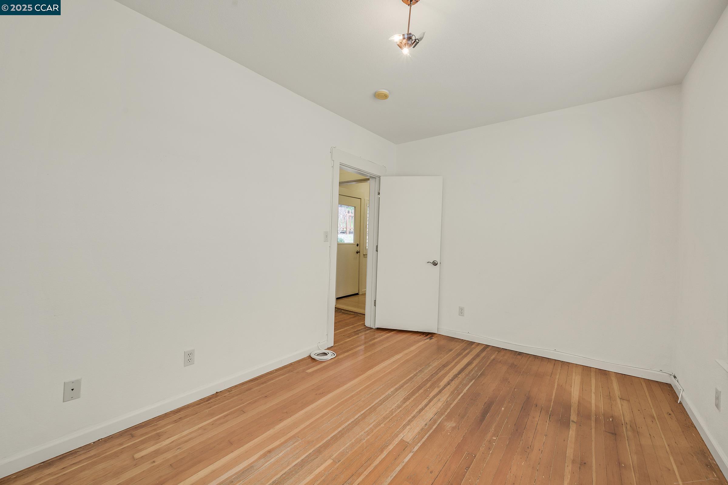 2581 Charles Avenue Pinole, CA 94564 - Photo 25 of 50 an empty room with wooden floor