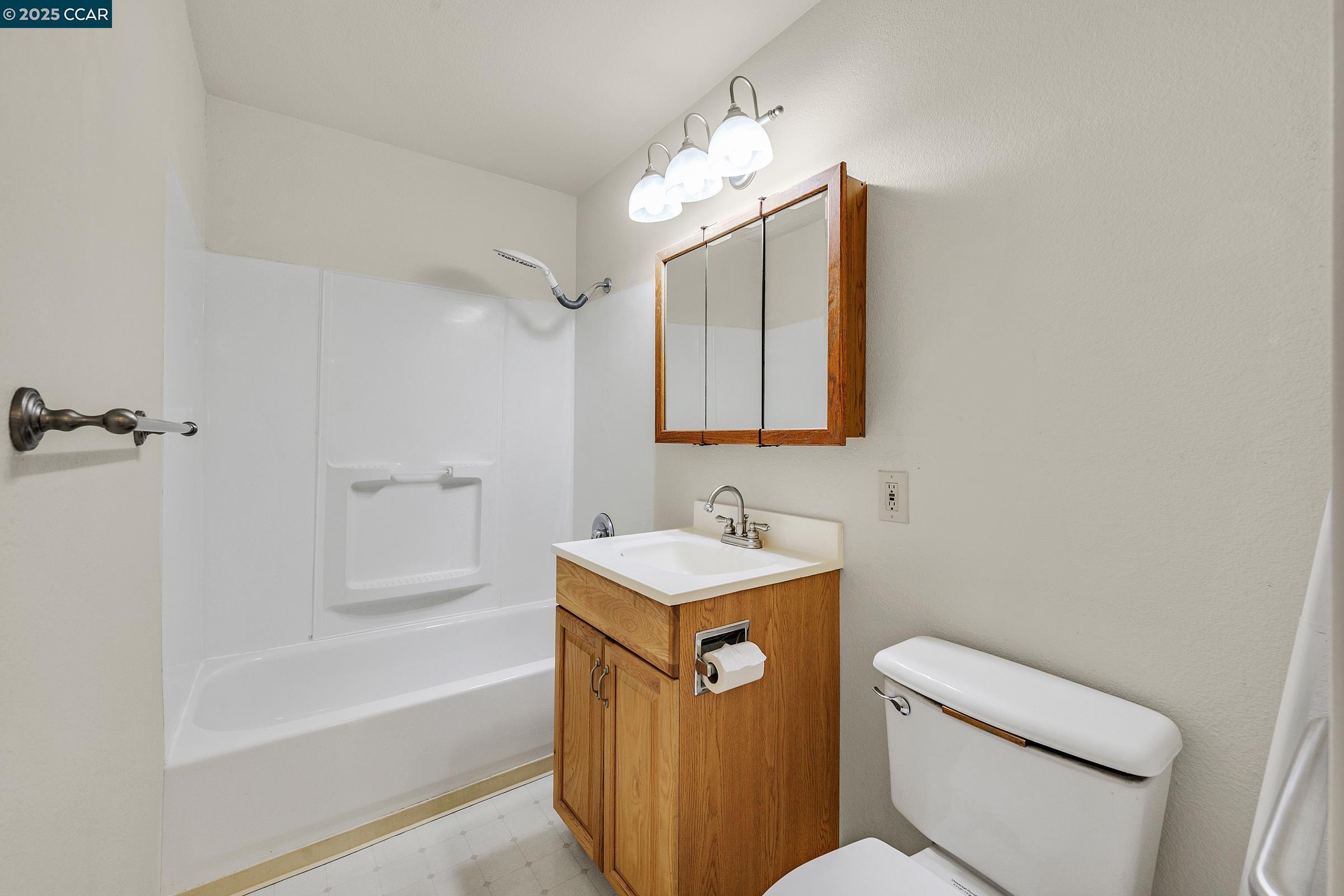 2581 Charles Avenue Pinole, CA 94564 - Photo 26 of 50 a bathroom with a sink toilet vanity and bathtub