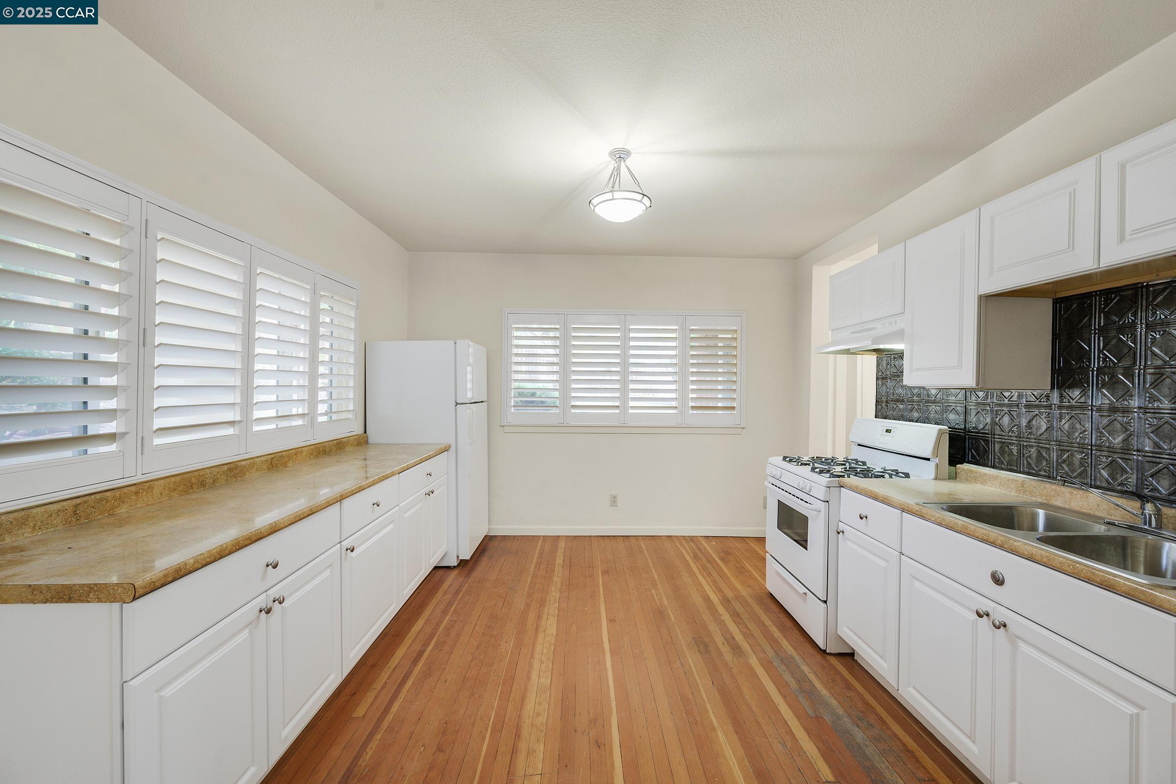 2581 Charles Avenue Pinole, CA 94564 - Photo 29 of 50 a large white kitchen with a large window a sink and stainless steel appliances