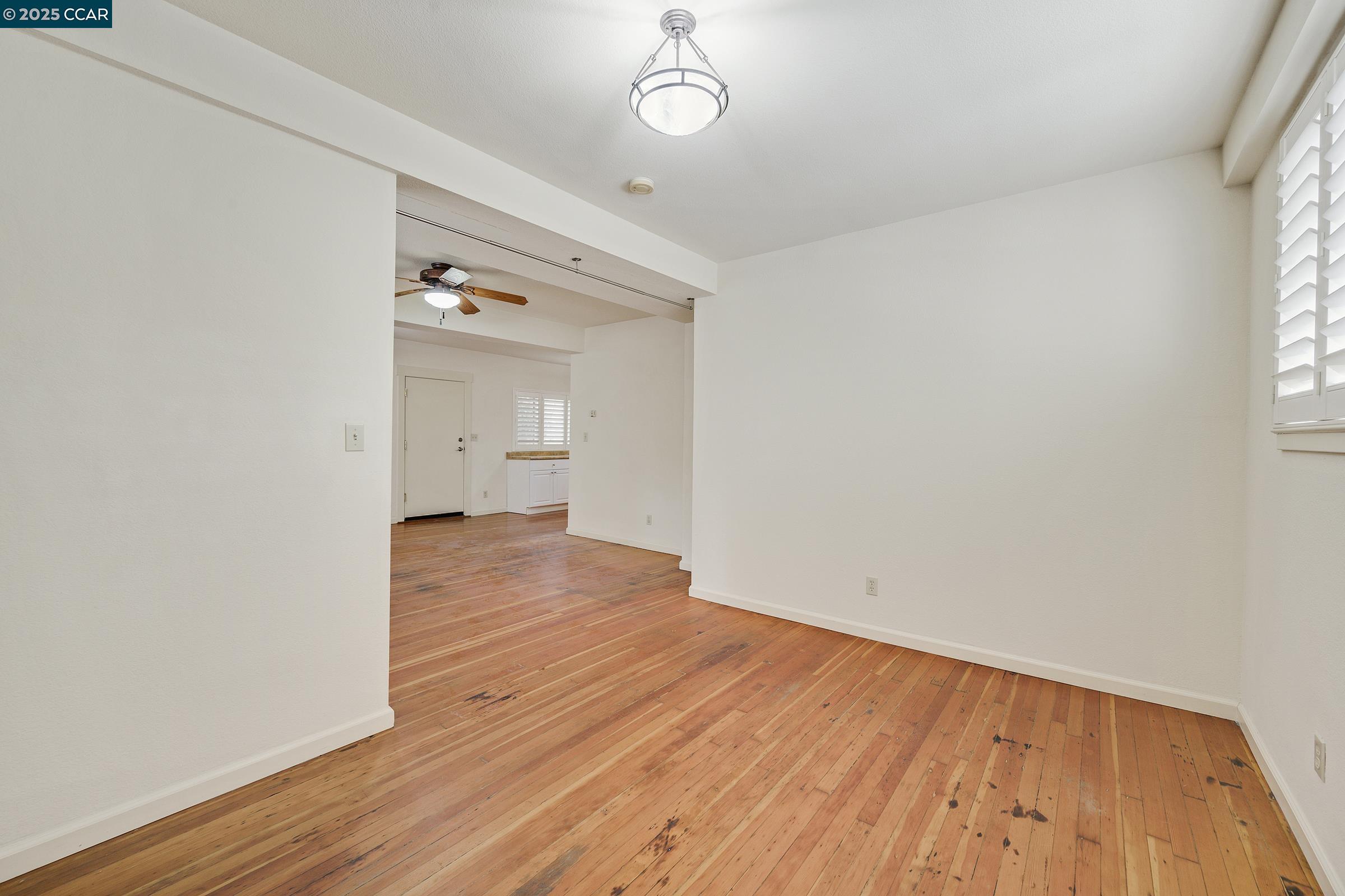 2581 Charles Avenue Pinole, CA 94564 - Photo 35 of 50 an empty room with wooden floor and windows