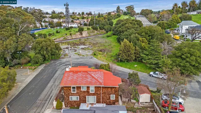an aerial view of a house with a yard basket ball court and outdoor seating