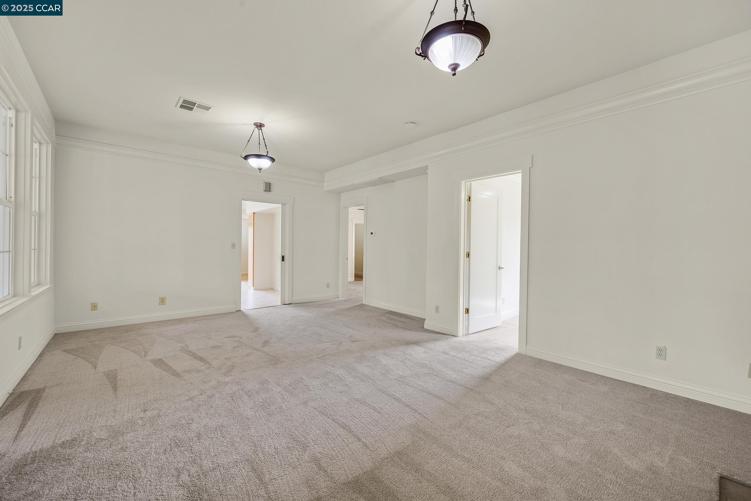 2581 Charles Avenue Pinole, CA 94564 - Photo 6 of 50 an empty room with chandelier fan and windows