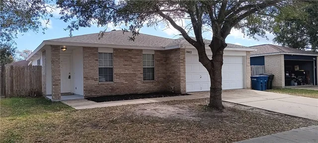 a view of a house with a tree in the yard