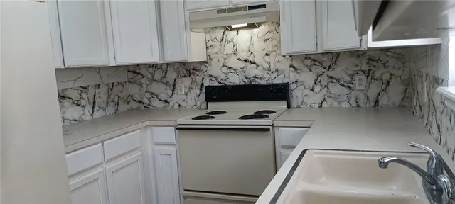 a kitchen with a sink and cabinets