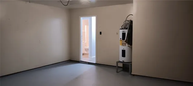 an empty room with wooden floor and white walls