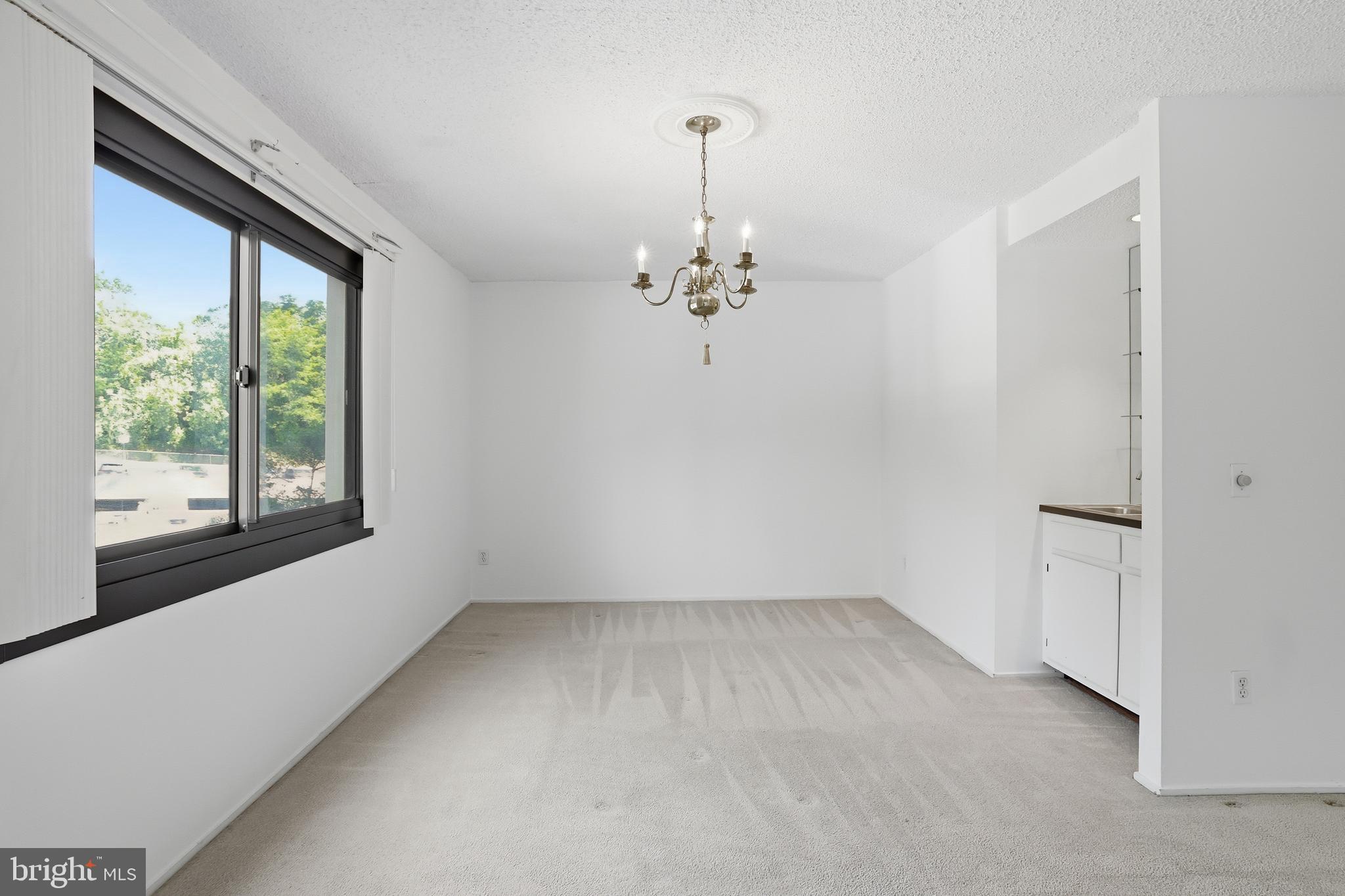 6101 Edsall Road, Unit 502 Alexandria, VA 22304 - Photo 6 of 33 Sunlit dining area with mini-bar