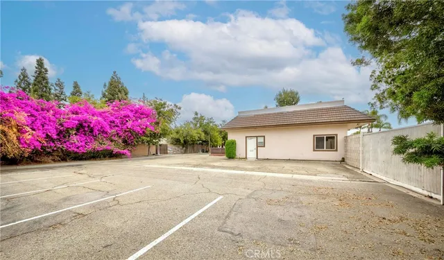 a view of a street with potted plants
