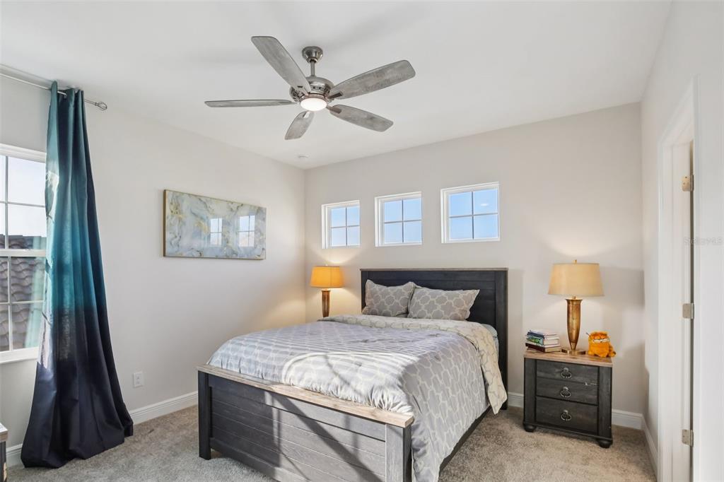 14930 Rider Pass Drive Lithia, FL 33547 - Photo 12 of 63 a bedroom with a bed and a chandelier