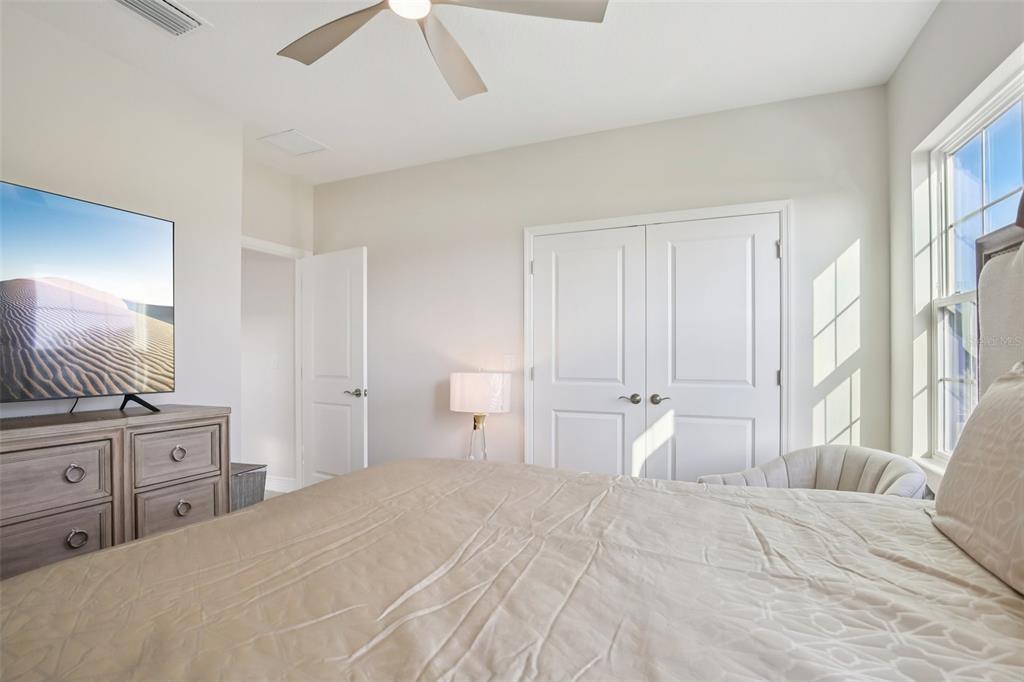 14930 Rider Pass Drive Lithia, FL 33547 - Photo 17 of 63 a spacious bedroom with a large bed and a chandelier