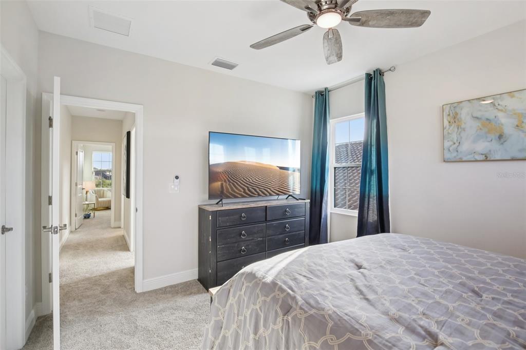 14930 Rider Pass Drive Lithia, FL 33547 - Photo 23 of 63 a bedroom with a bed and a chandelier