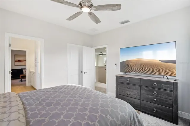 a living room with furniture and a air conditioner vent